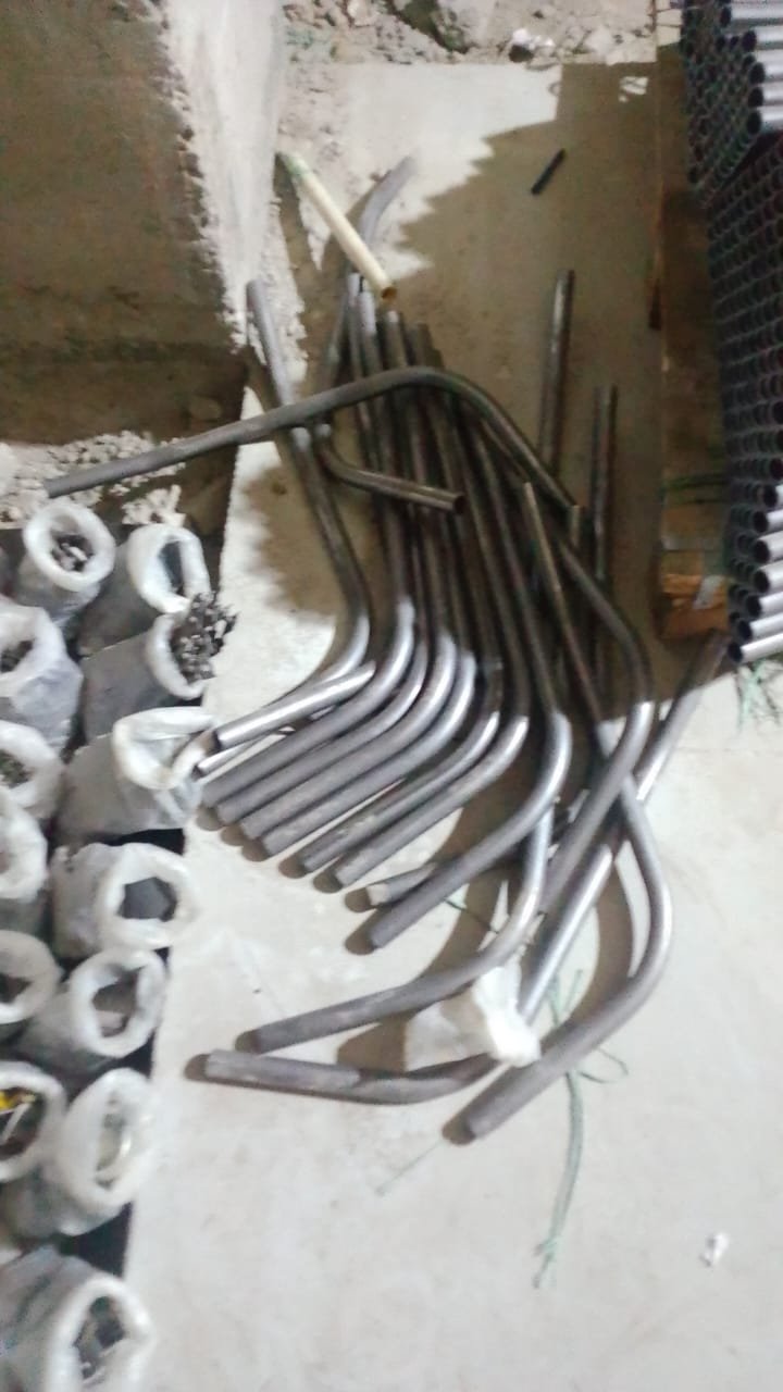 Freshly CNC-bent tube components stacked for inspection
